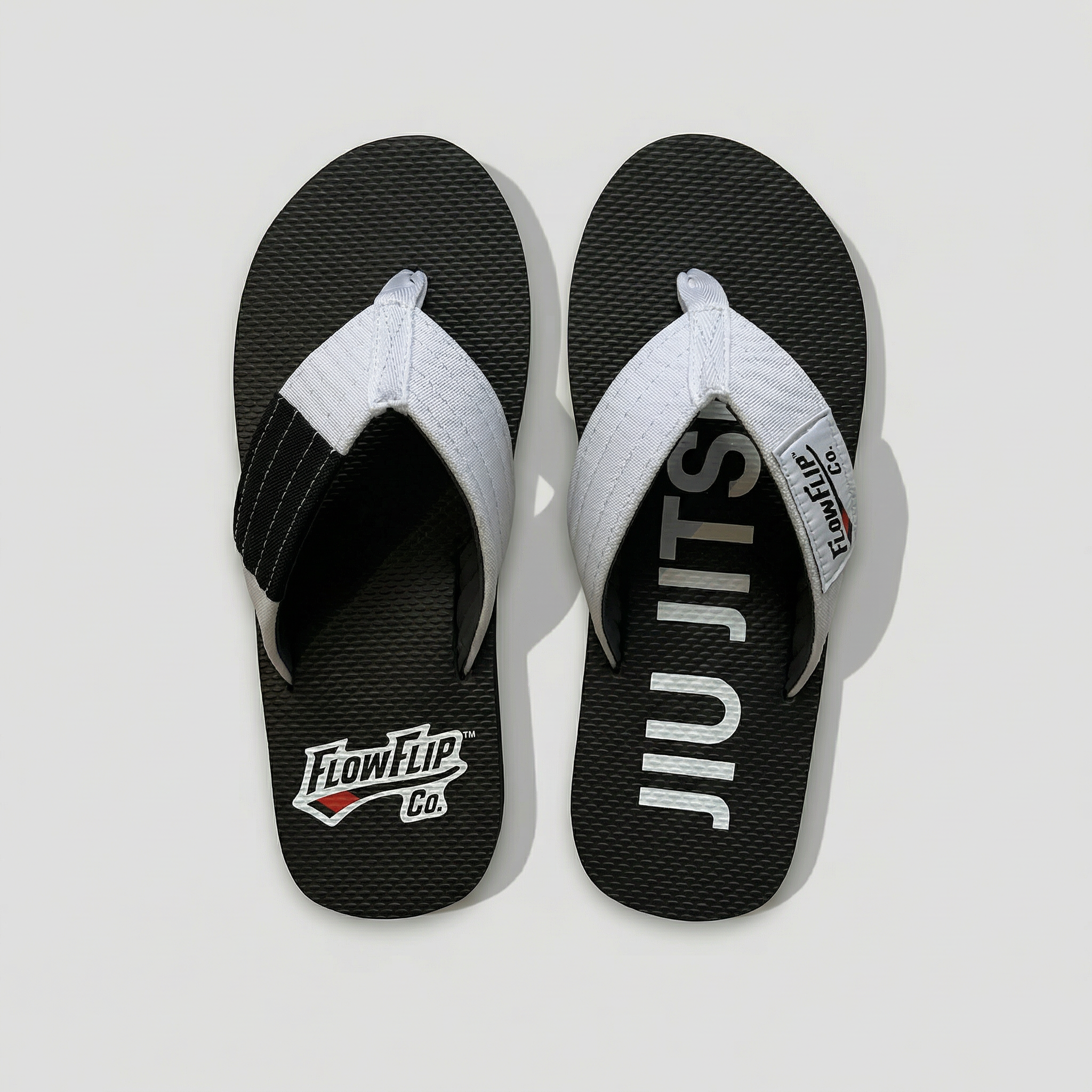 Adult white belt BJJ flip flops with white strap and black rank bar.