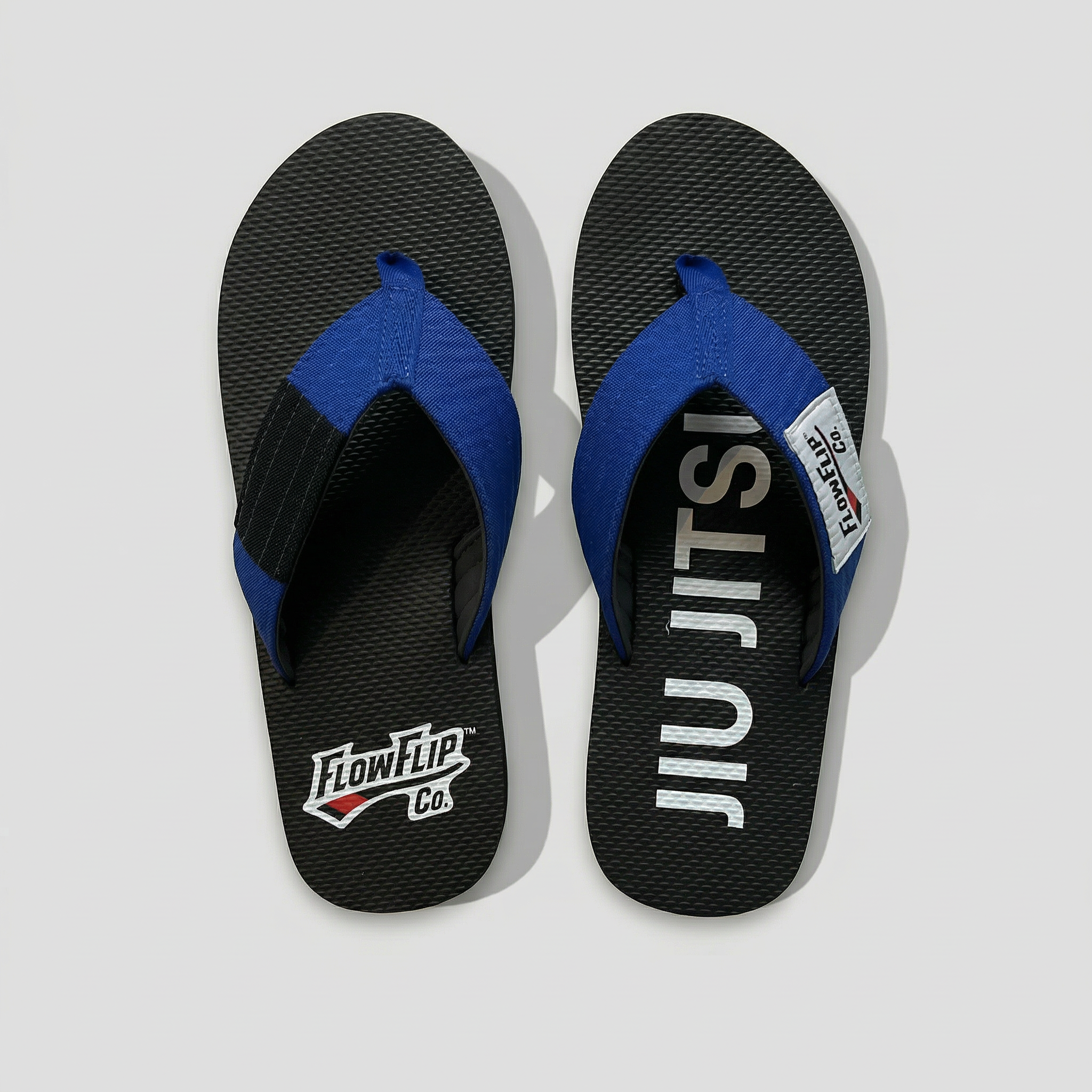 Blue belt BJJ flip flops with blue strap and black rank bar.