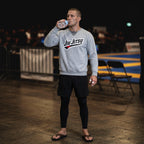Grey Jiu Jitsu crewneck sweatshirt worn after training.