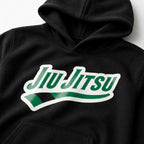 Close-up of green rank chest artwork on black Jiu Jitsu hoodie.