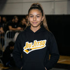 Yellow belt Jiu Jitsu hoodie worn in a BJJ academy setting with yellow rank chest artwork visible.